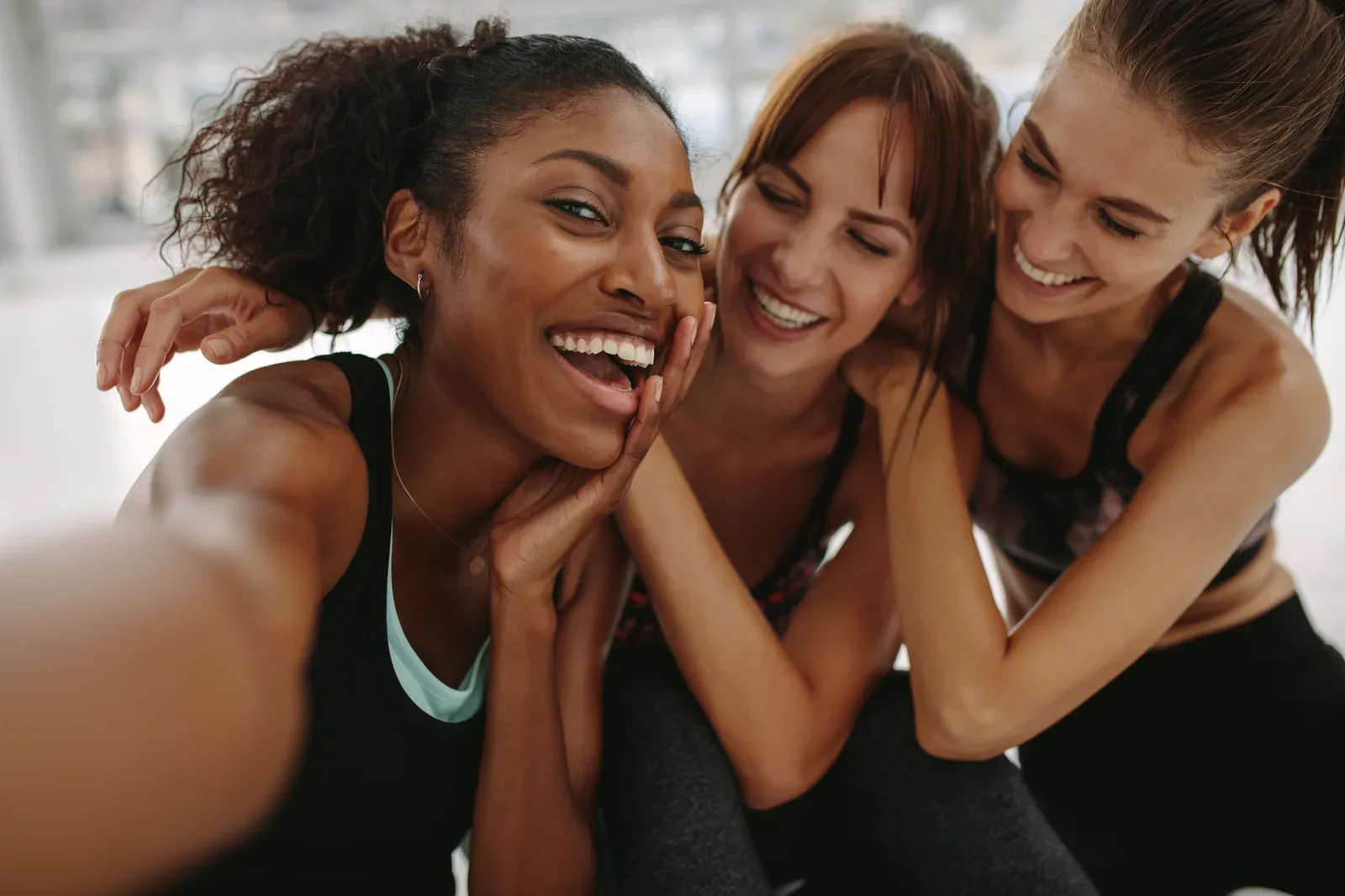 Group of women laughing together during a workout