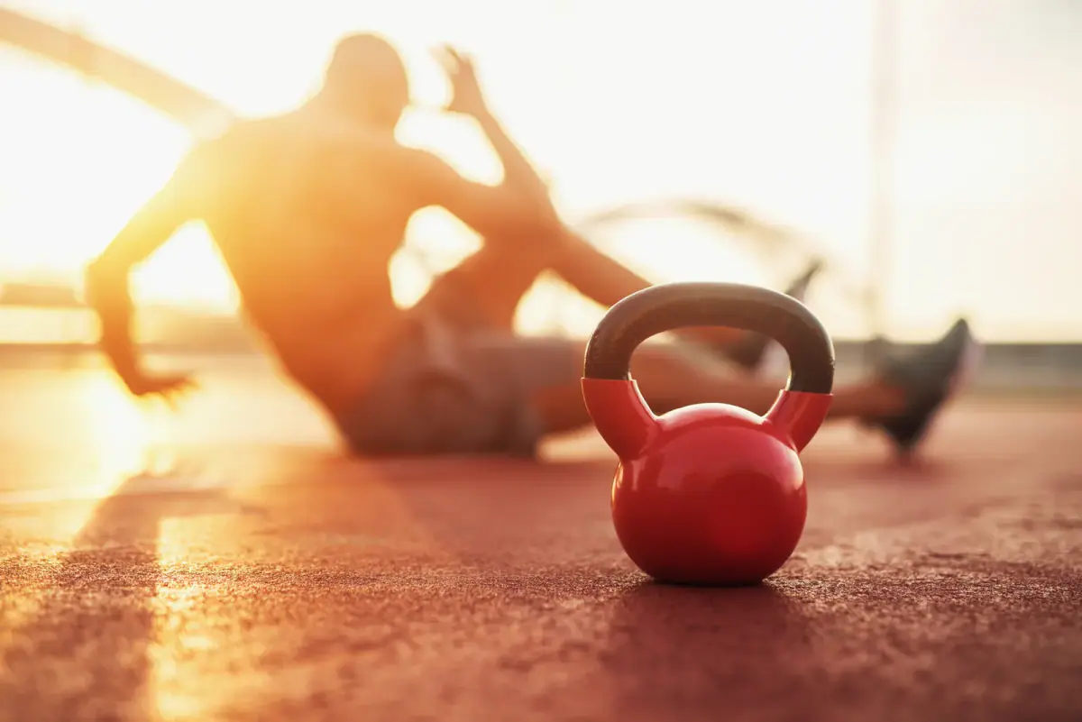Kettlebell in focus during early morning fitness training, a time slot that suits a side hustle personal trainer