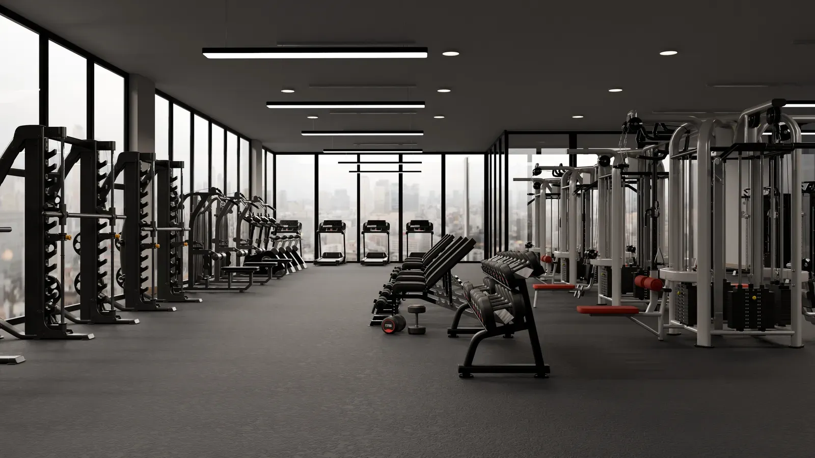 Empty, fully equipped gym interior with the lights on and nobody inside