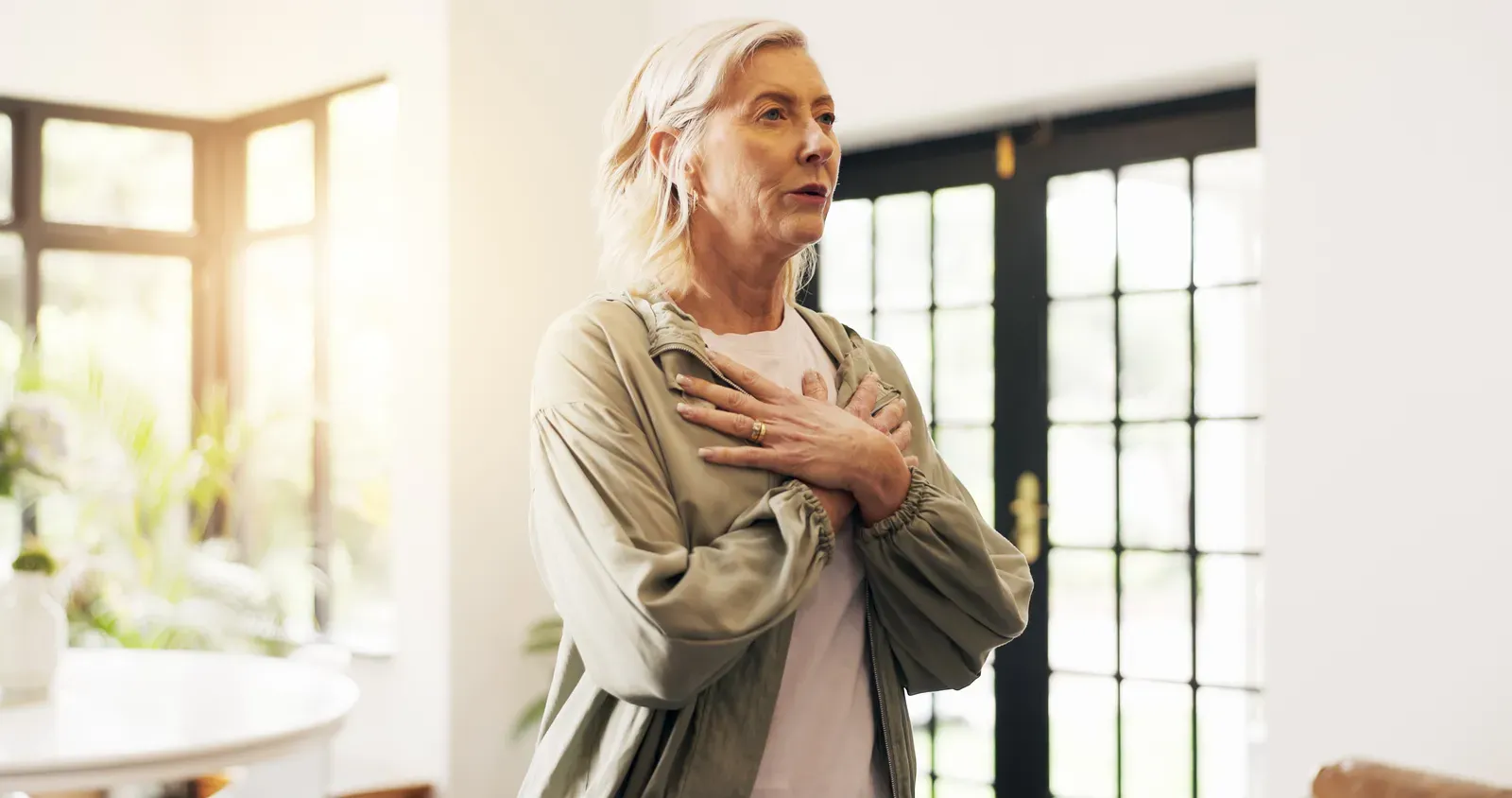 A person seated with eyes closed practicing a slow breathing exercise