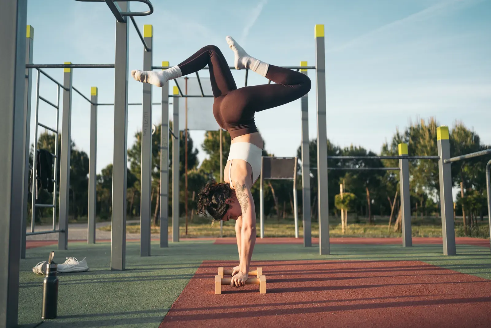 An athlete holding a straight-arm support position during bodyweight training