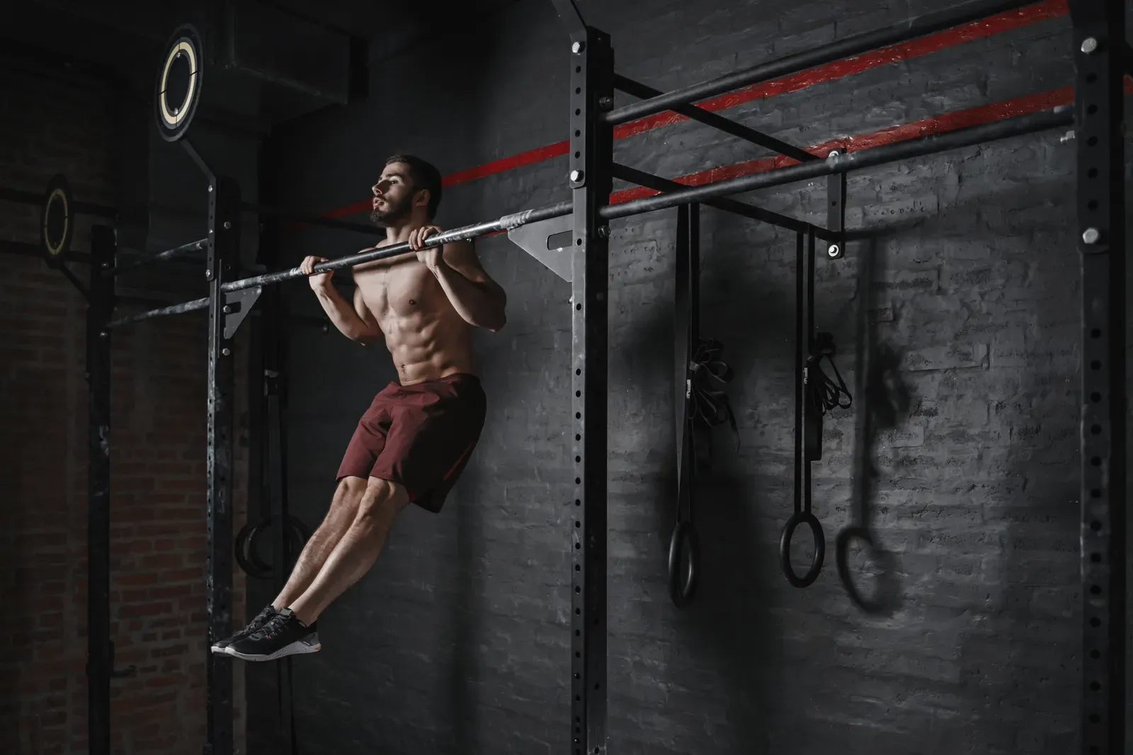 A climber performing a controlled pull-up during strength training