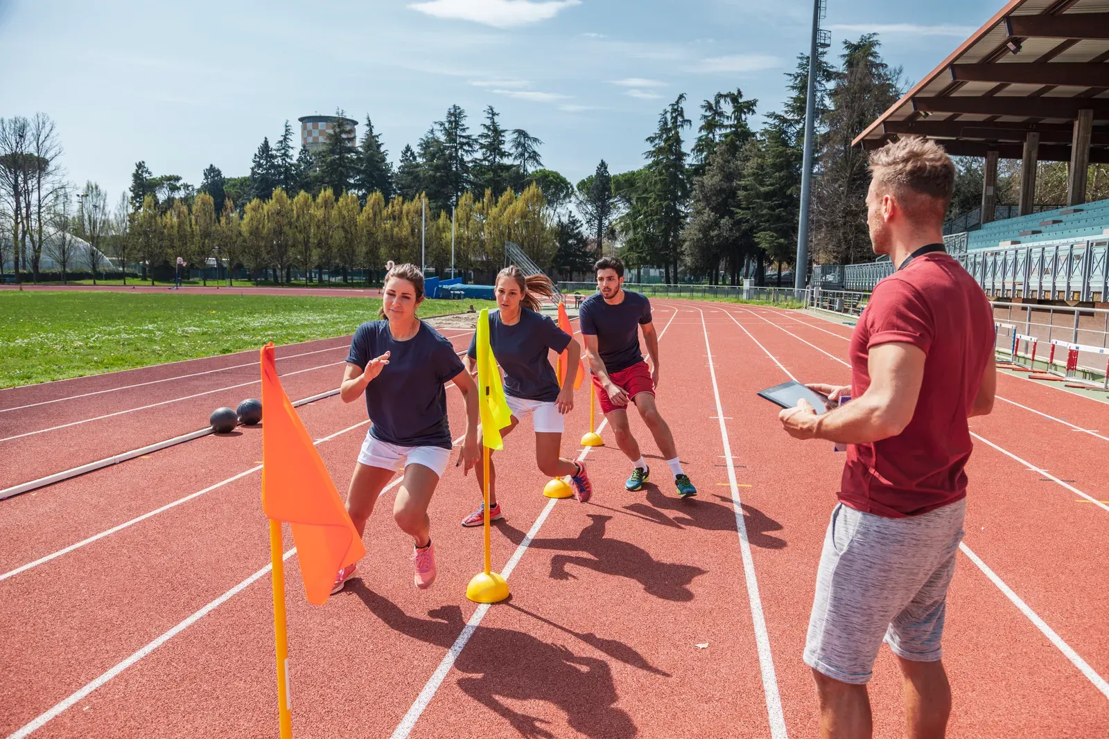 College athletes working through a strength session with dumbbells