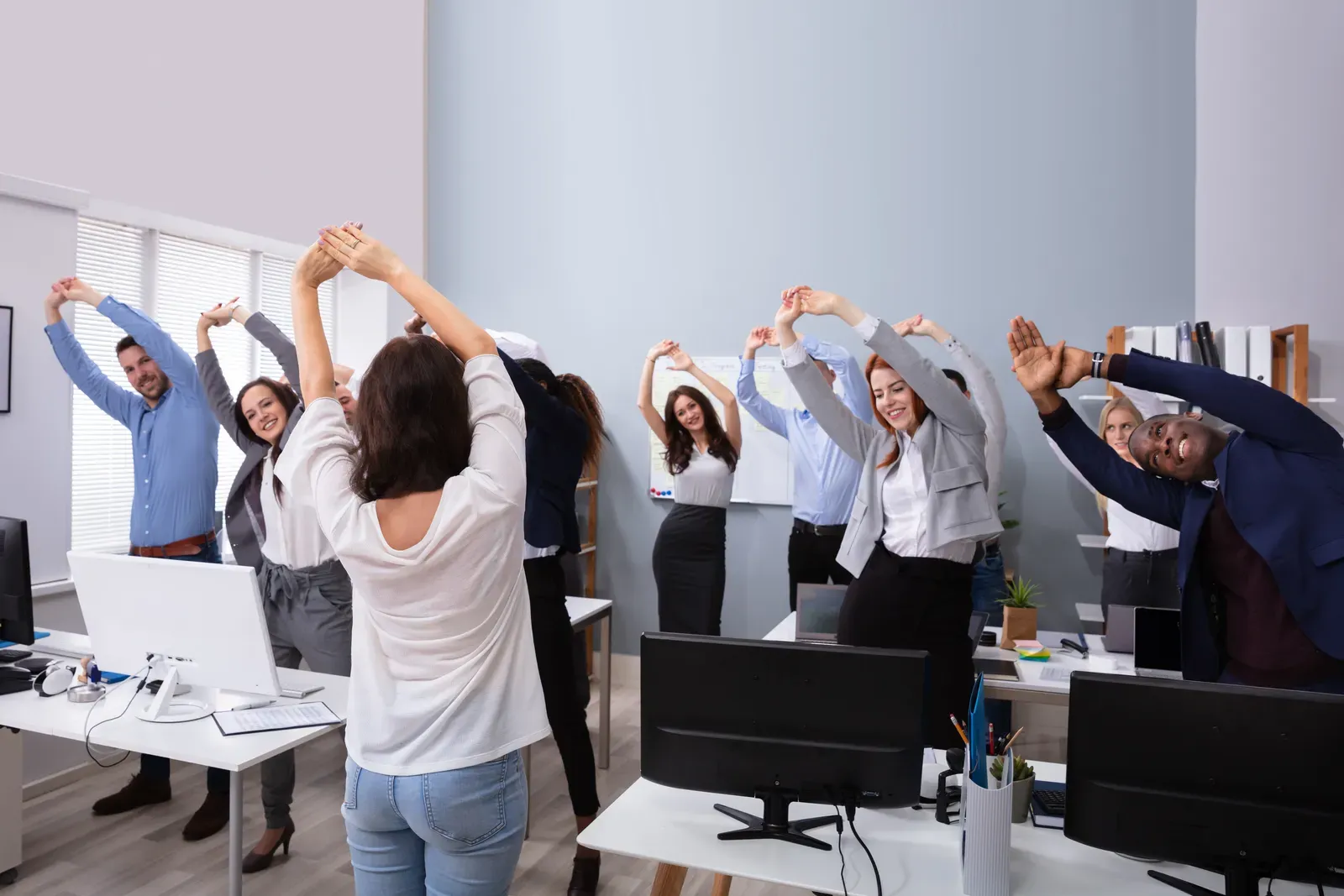 Coworkers in athletic wear training together during a team wellness session