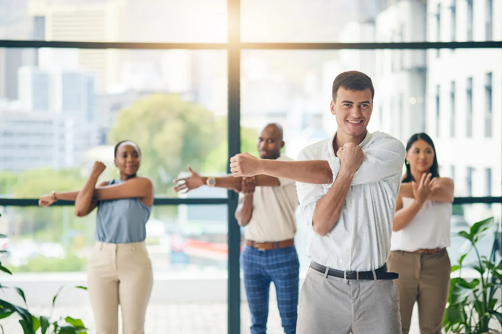 Employees stretching together during a workplace wellness session