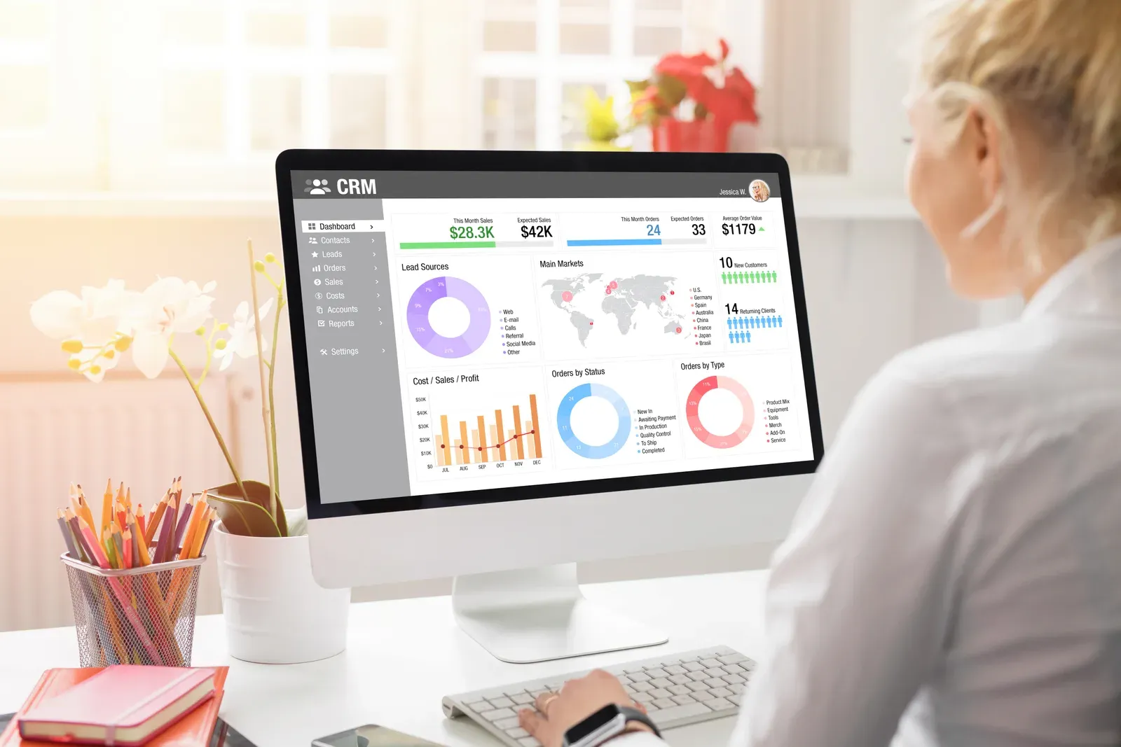 A business owner reviewing a client pipeline on a computer screen