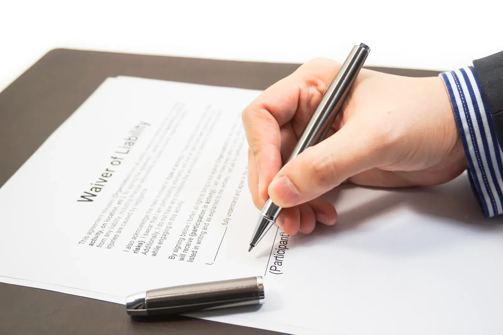 Signing a liability waiver form, the document trainers count on for protection