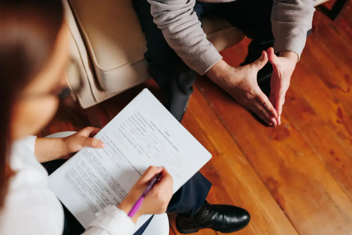 Counselor holding a session with a client in a cozy, warm interior, a calm setting for private eating disorder dietitian sessions