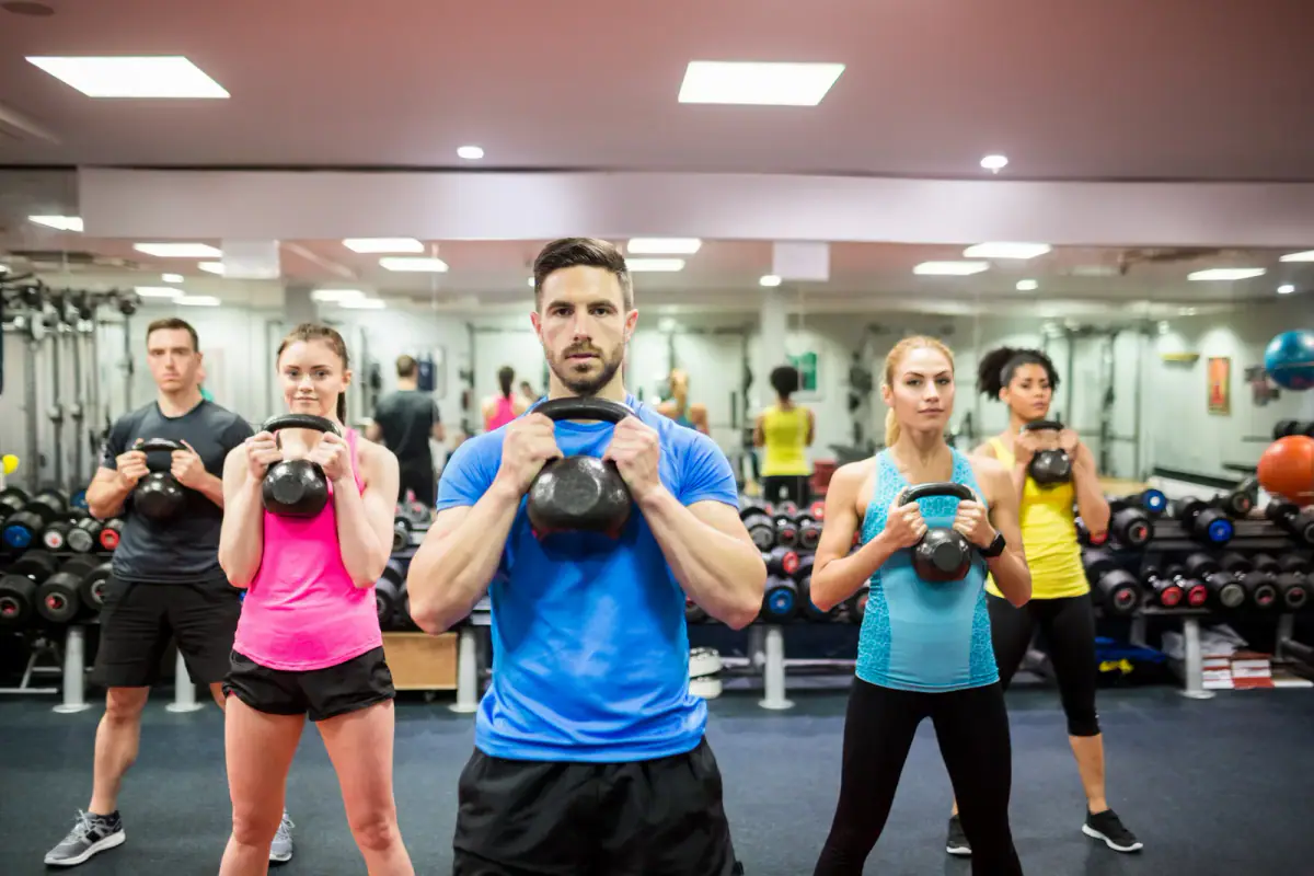 Fit people working out in a fitness class, a group setting that shapes an equipment list for small group conditioning