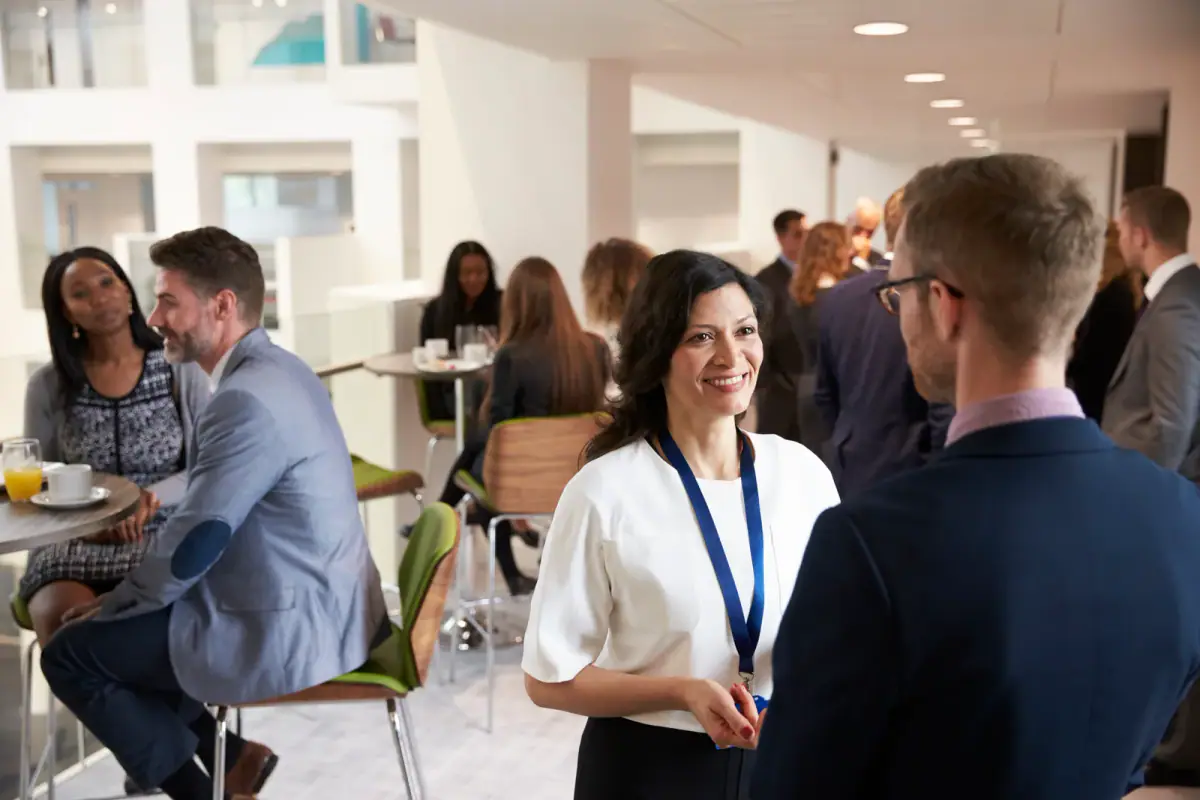 Conference attendees networking over coffee during an event break