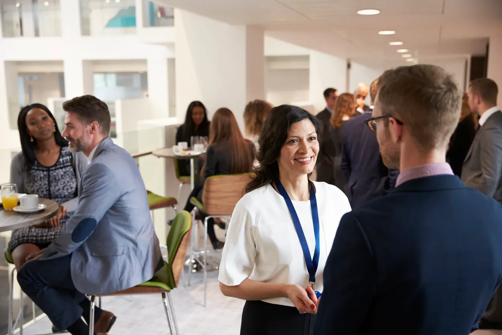 Conference attendees networking over coffee during an event break