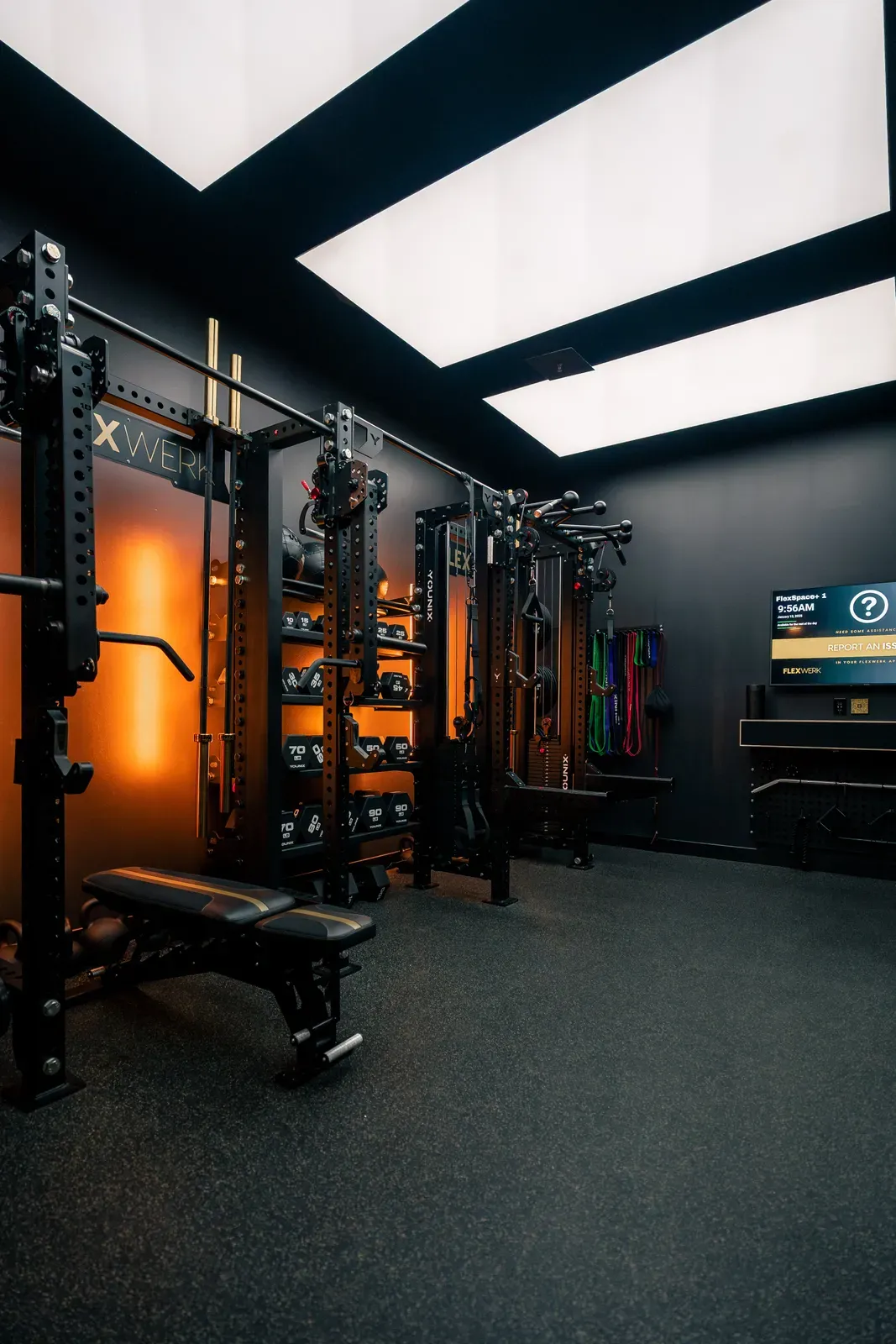 Dumbbell rack and adjustable bench ready inside a private training room