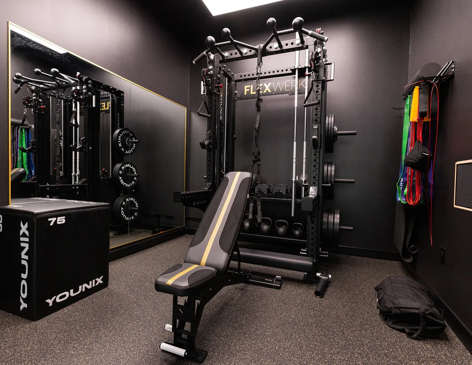 Lifting rack, mirror, and bench inside a private workout space at FlexWerk Carmel