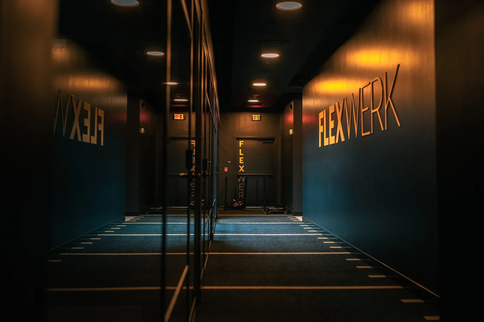 Turf corridor leading past private workout spaces at FlexWerk in Carmel