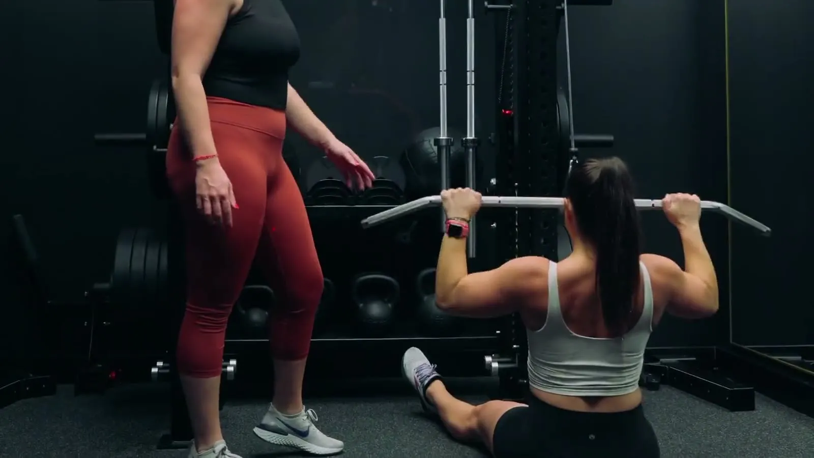 Working through cable pulldowns beside the dumbbell rack in a private FlexWerk space