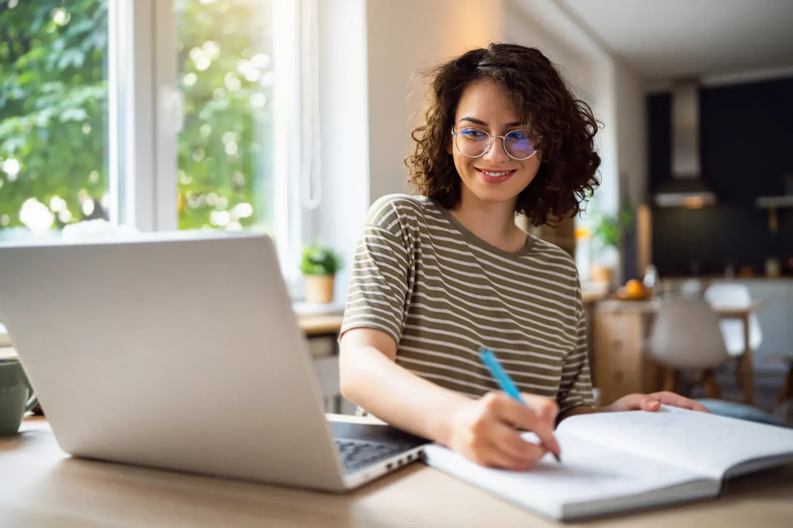 Young woman studying an online course, weighing a GLP-1 coaching certification