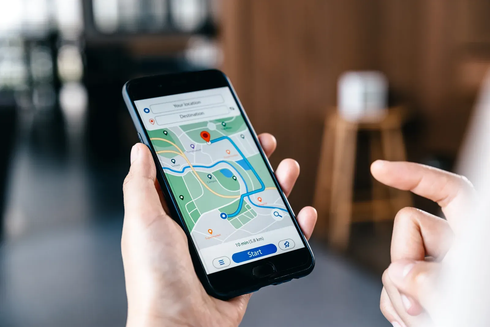 A person searching for local businesses on a phone map app