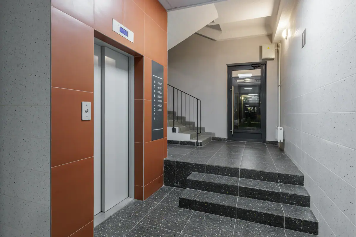 Modern apartment building hallway with an elevator and stairs, a way to compare ground floor and upstairs training space