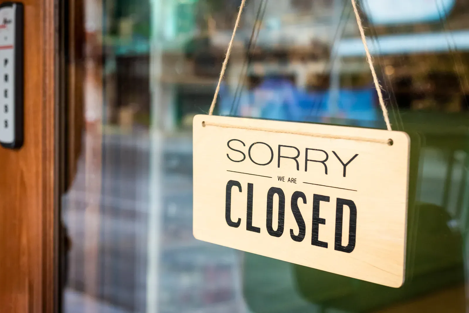 Closed sign hanging on the glass door of a gym