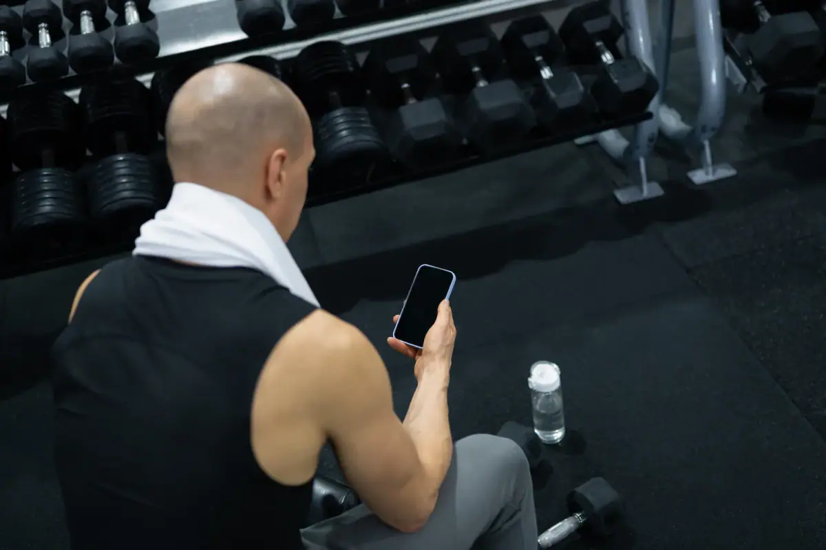Trainer with a notebook evaluating an empty gym space