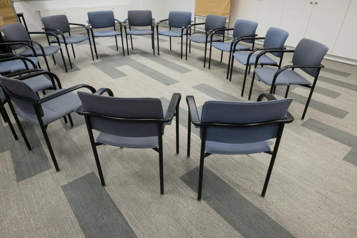 Circle of chairs in a room set up for a workshop, a layout for a health coach group program room