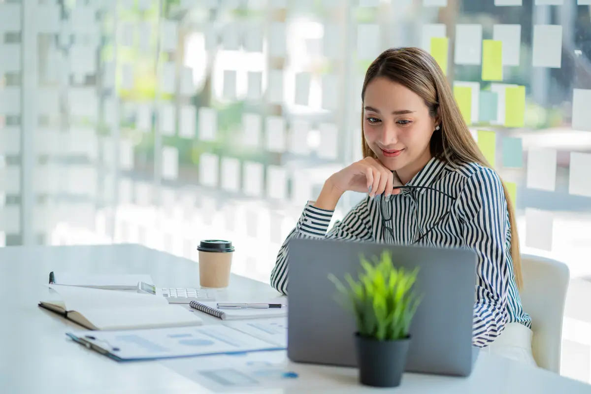 Business analyst or accountant examining financial documents, the type of help a trainer gets when hiring a CPA