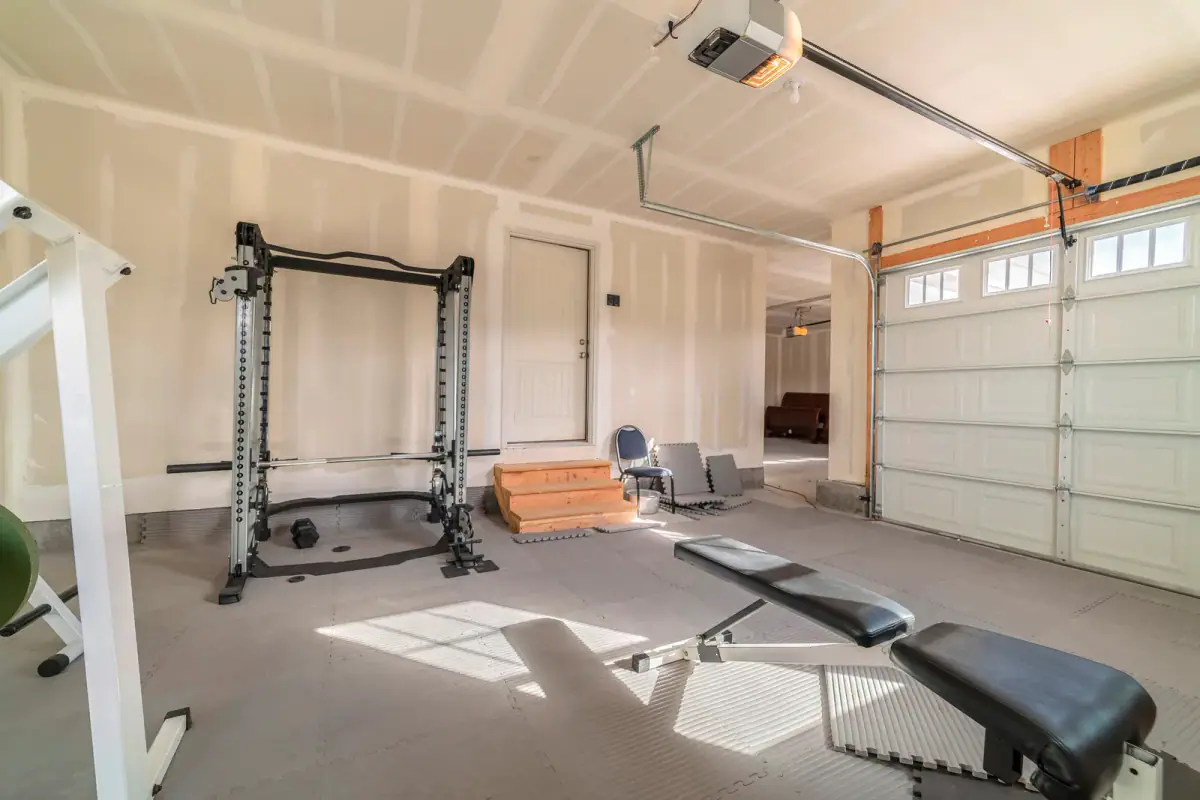 Assorted gym and fitness equipment in a garage, a home setup where HOA rules for training clients may apply