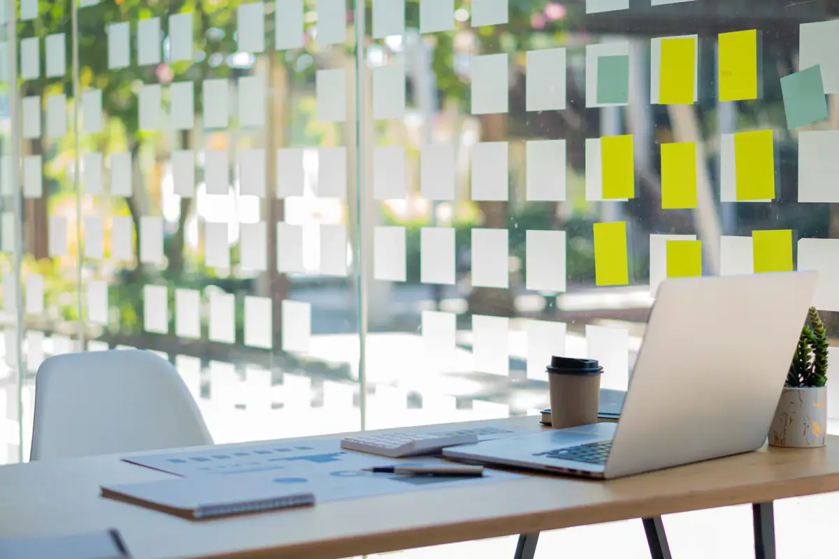 Laptop on a business desk with graphs, documents, mugs and calculators, a setup for building rent into your session price
