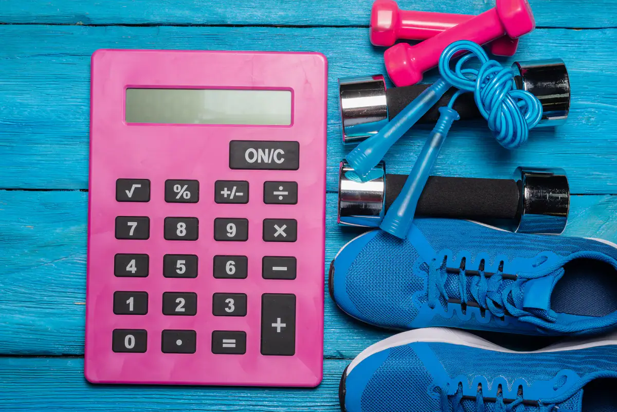 Budgeting hourly training room costs with a calculator and notebook