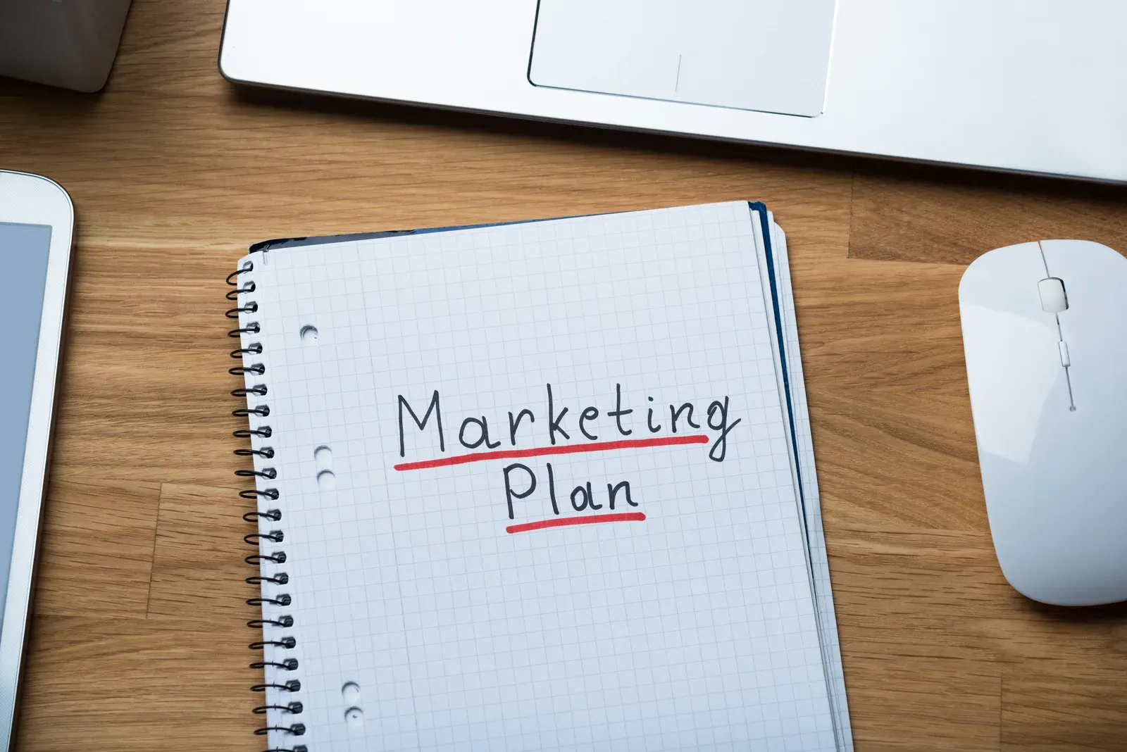 Marketing plan handwritten on a notepad at an office desk