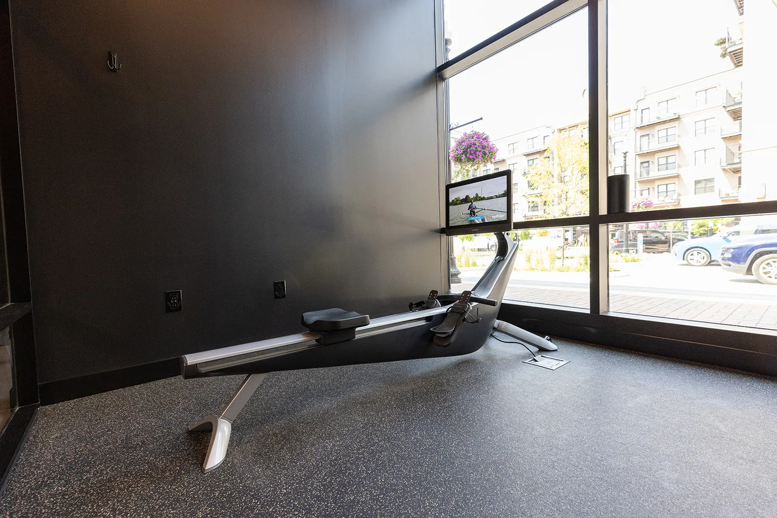 A HYDROW rower facing floor-to-ceiling windows in a private FlexSpace