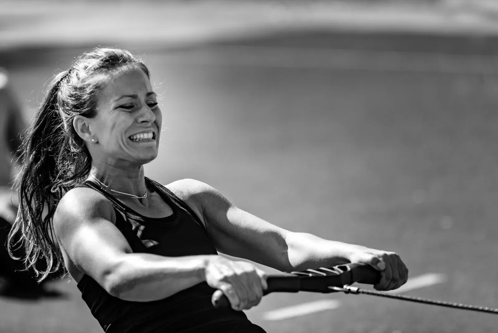 Athlete pulling hard on a rowing machine during an interval