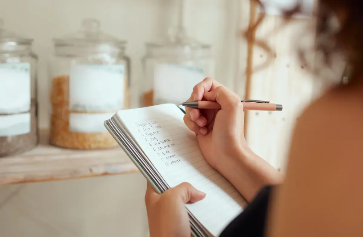 Budget planning with a shopping list and household expenses, much like tracking independent personal trainer monthly expenses