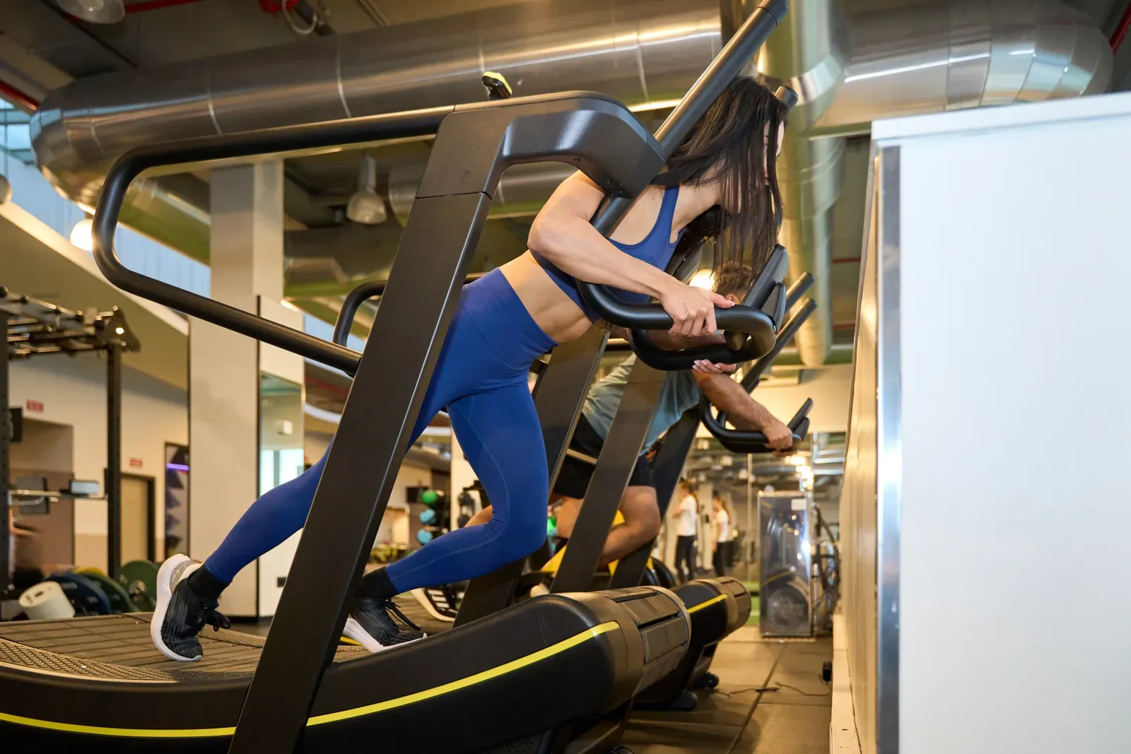 Runner training on a curved treadmill indoors