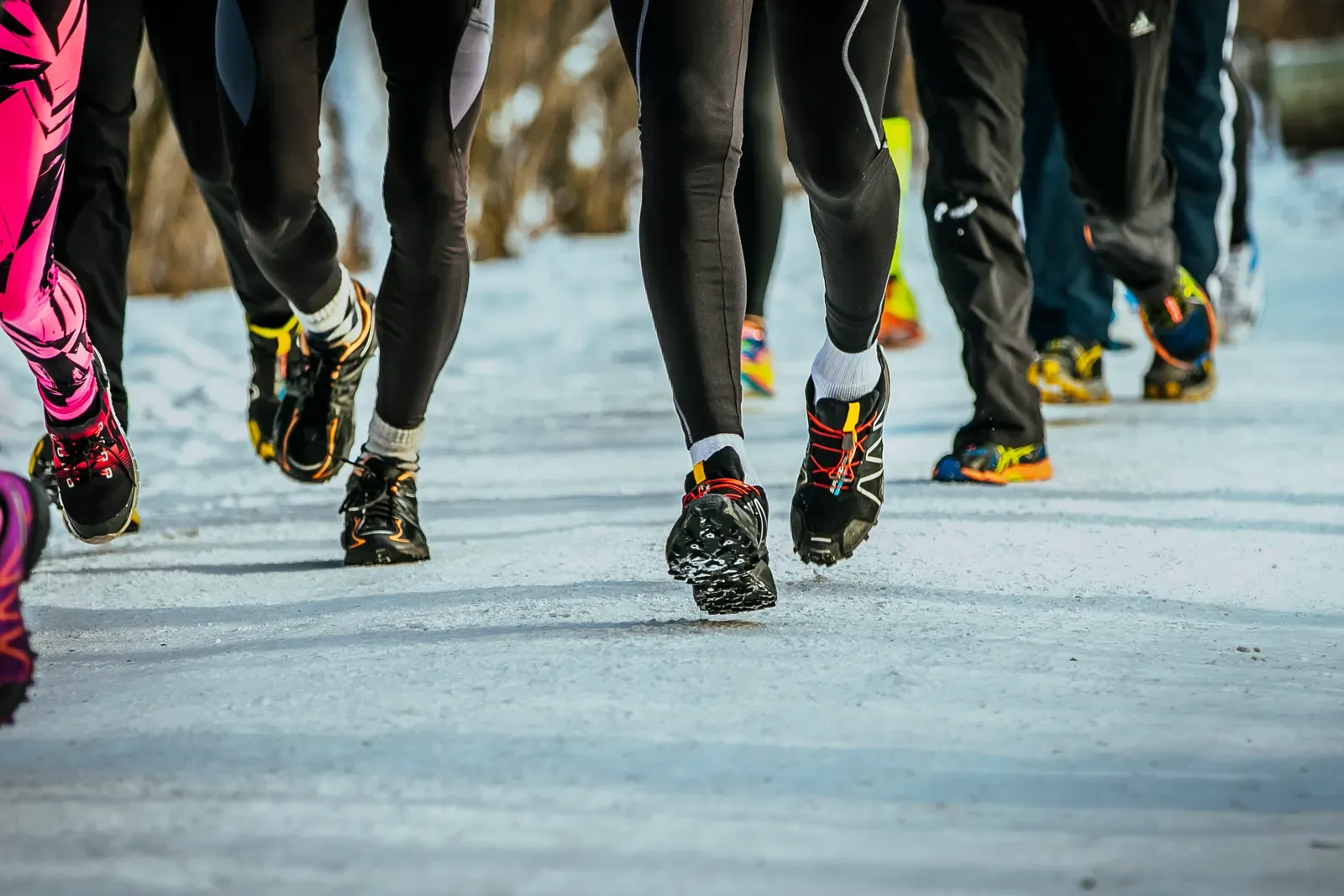 Runners in winter gear finishing a cold outdoor group run