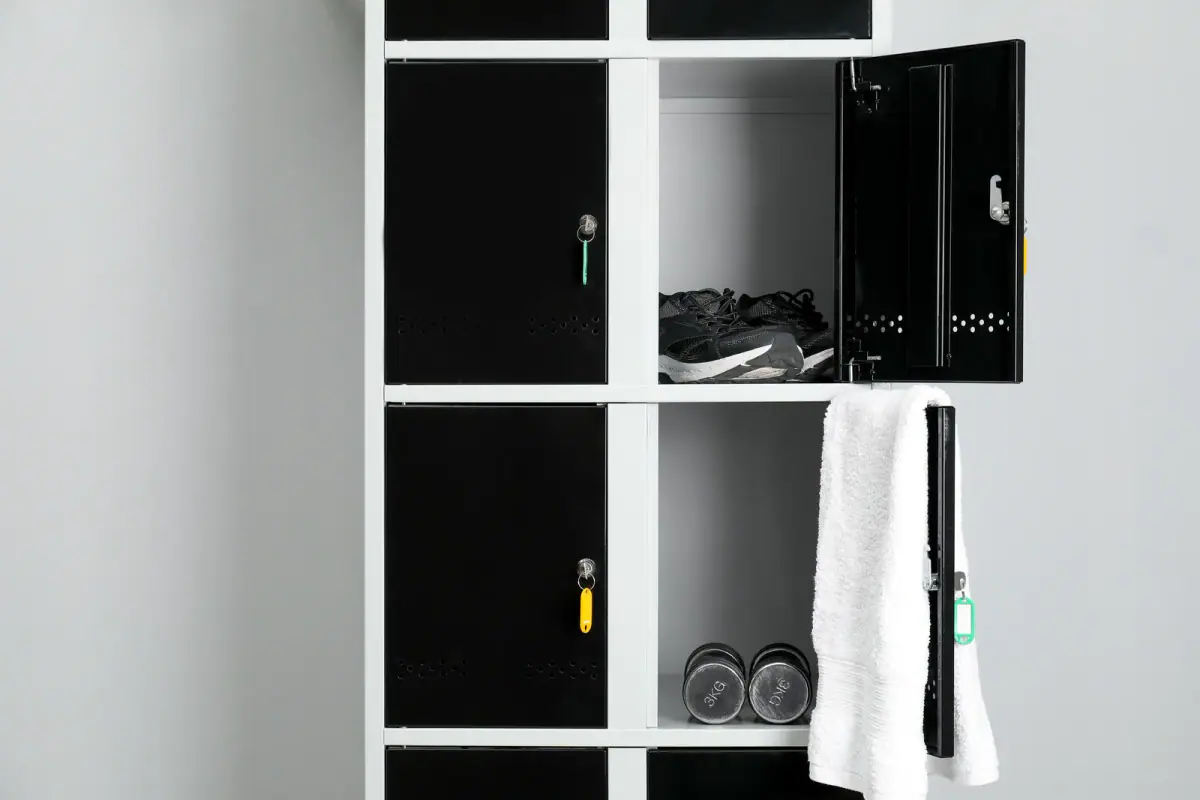 Personal gym belongings stored in a changing room, a reminder to insure training equipment you keep off site