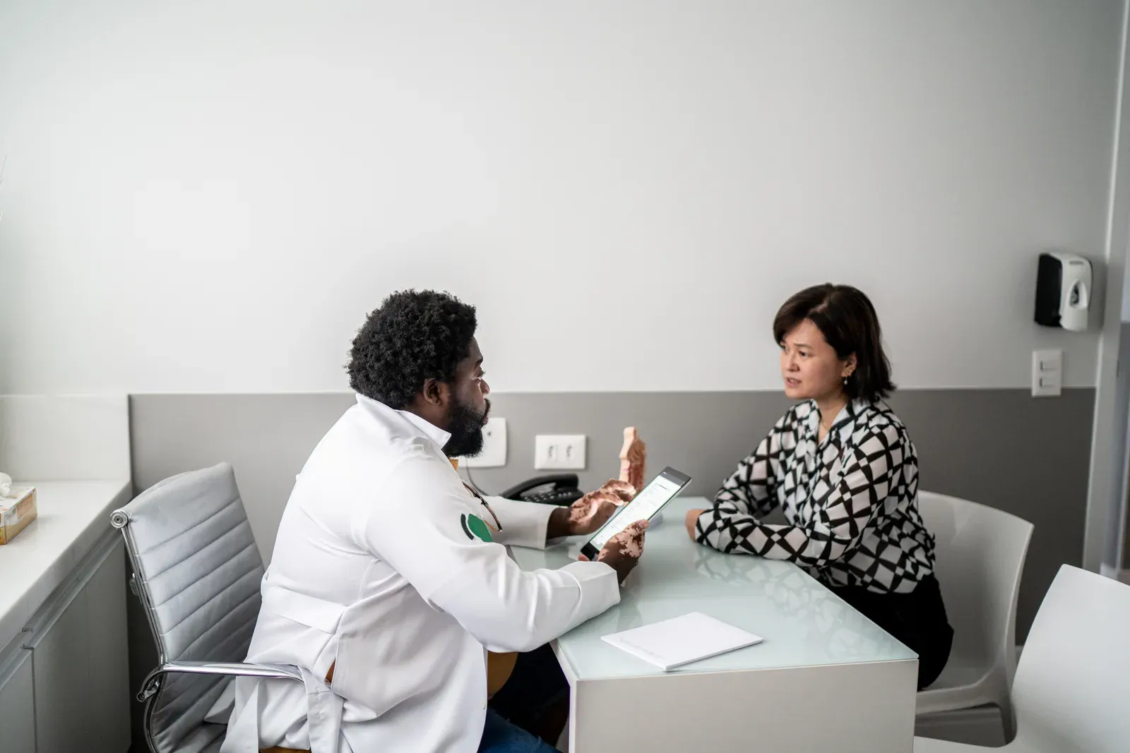 A physician talking with a patient in a bright clinic office