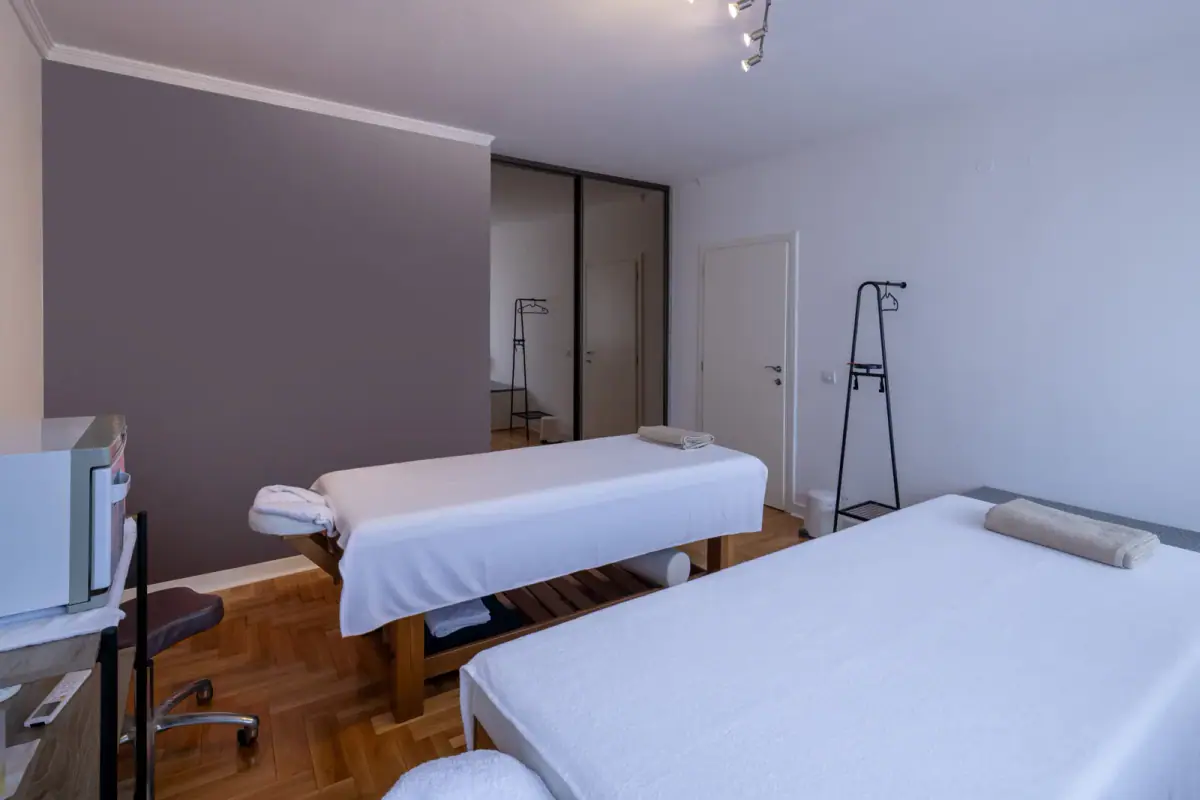 Massage therapy room with two tables, a space that needs a plan for massage linens and laundry in a rented room