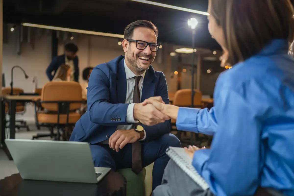 Business professionals shaking hands to reach an agreement in an office, a courteous way to give notice when leaving a gym