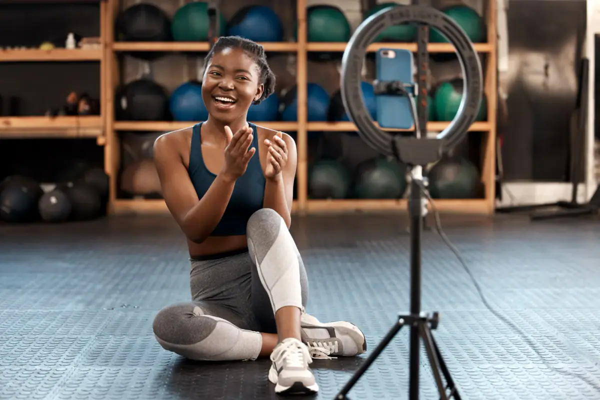 Sporty woman recording herself exercising in a gym to build her personal brand