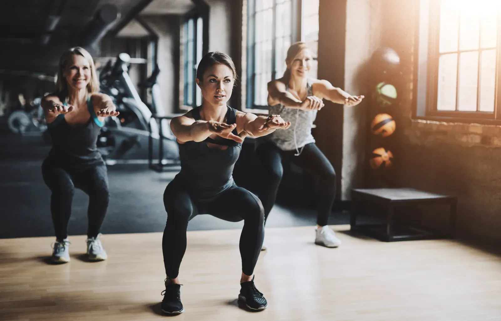 Trainer arranging equipment inside a small personal training studio
