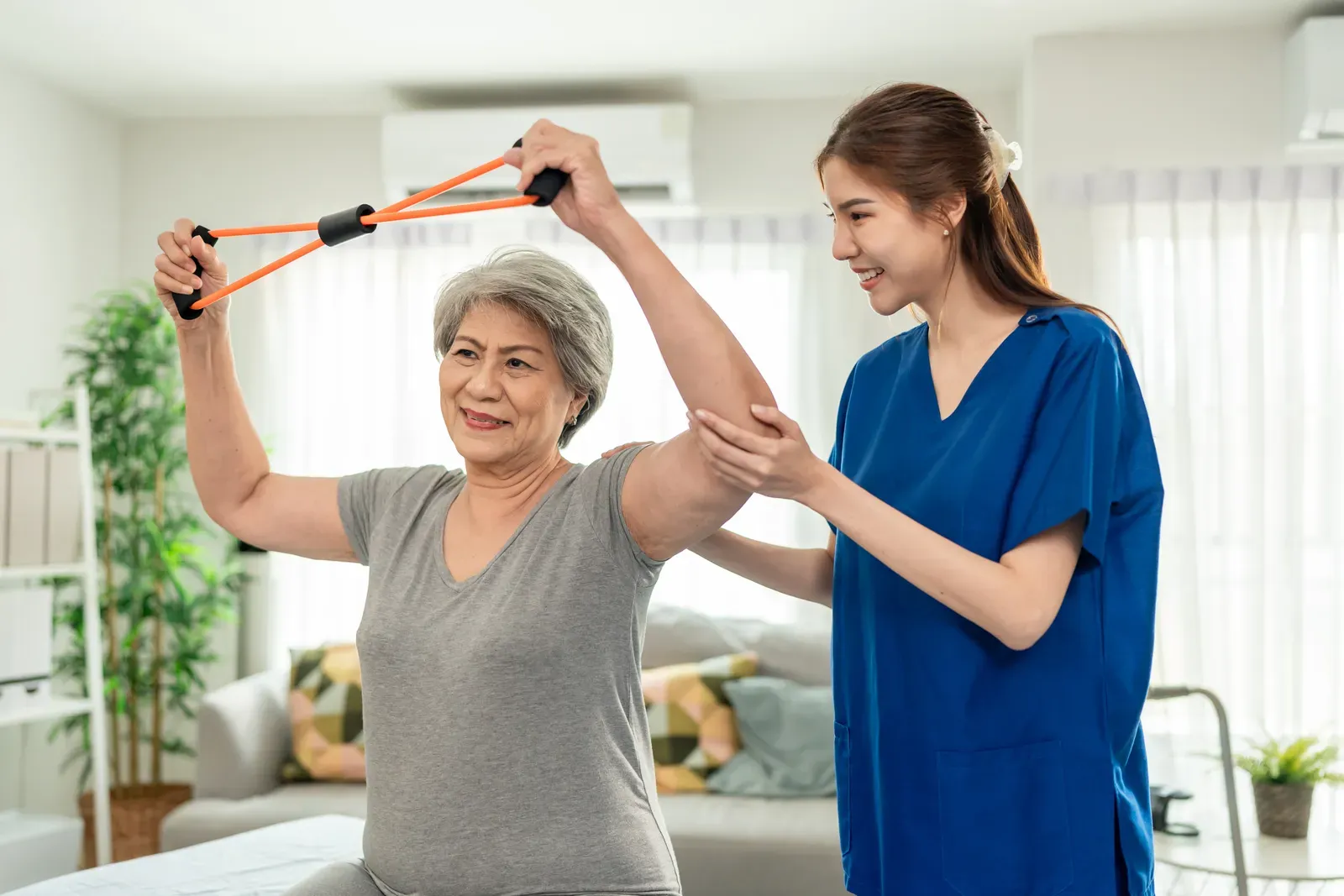 Physical therapist guiding a patient through a strengthening exercise