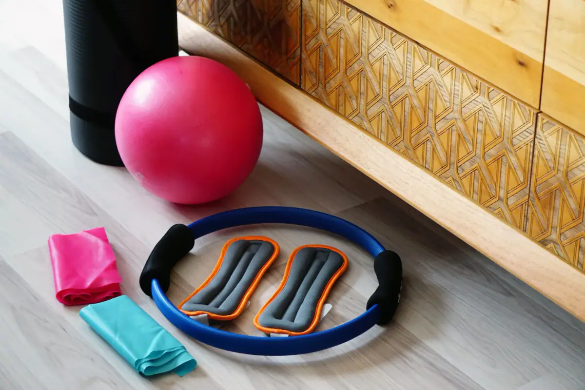 Pilates set with a mat and stretch ball on a floor, light gear for portable pilates equipment in private sessions