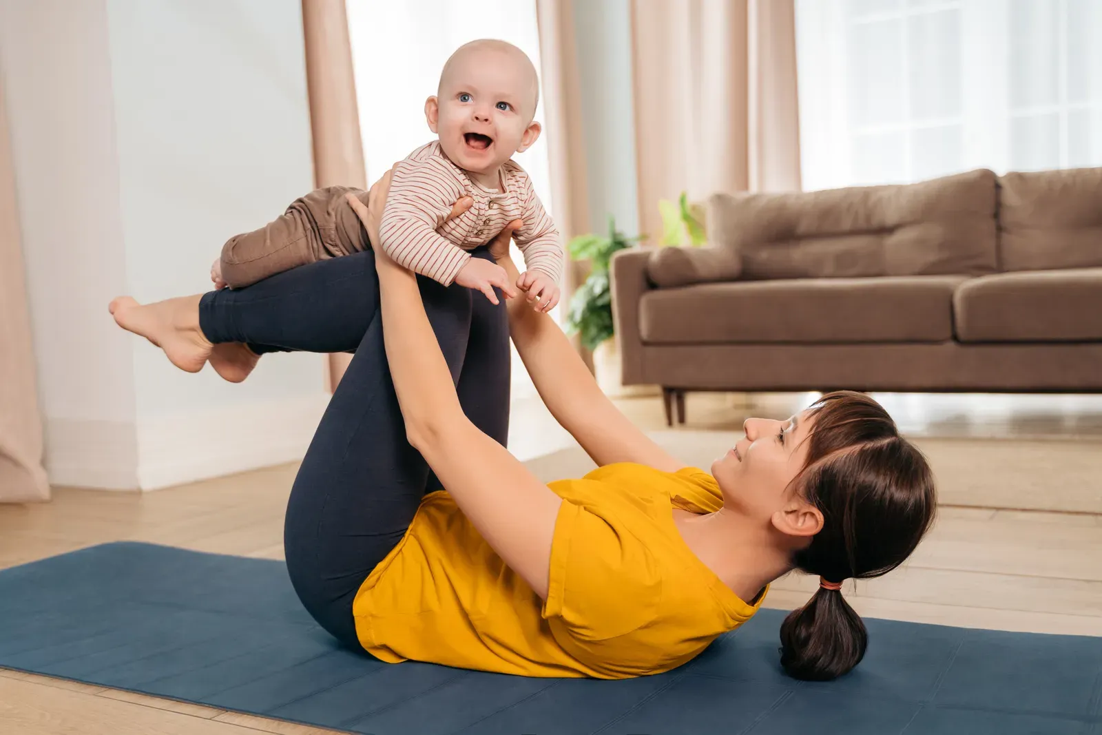New mother doing gentle core work with an instructor kneeling beside her
