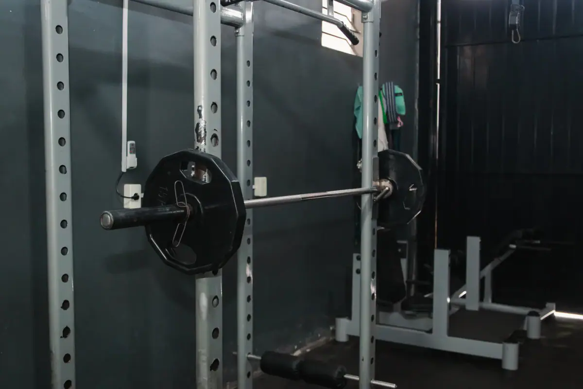 Squat cage with a barbell in the gym, a piece to weigh in power rack vs squat stand for a private room