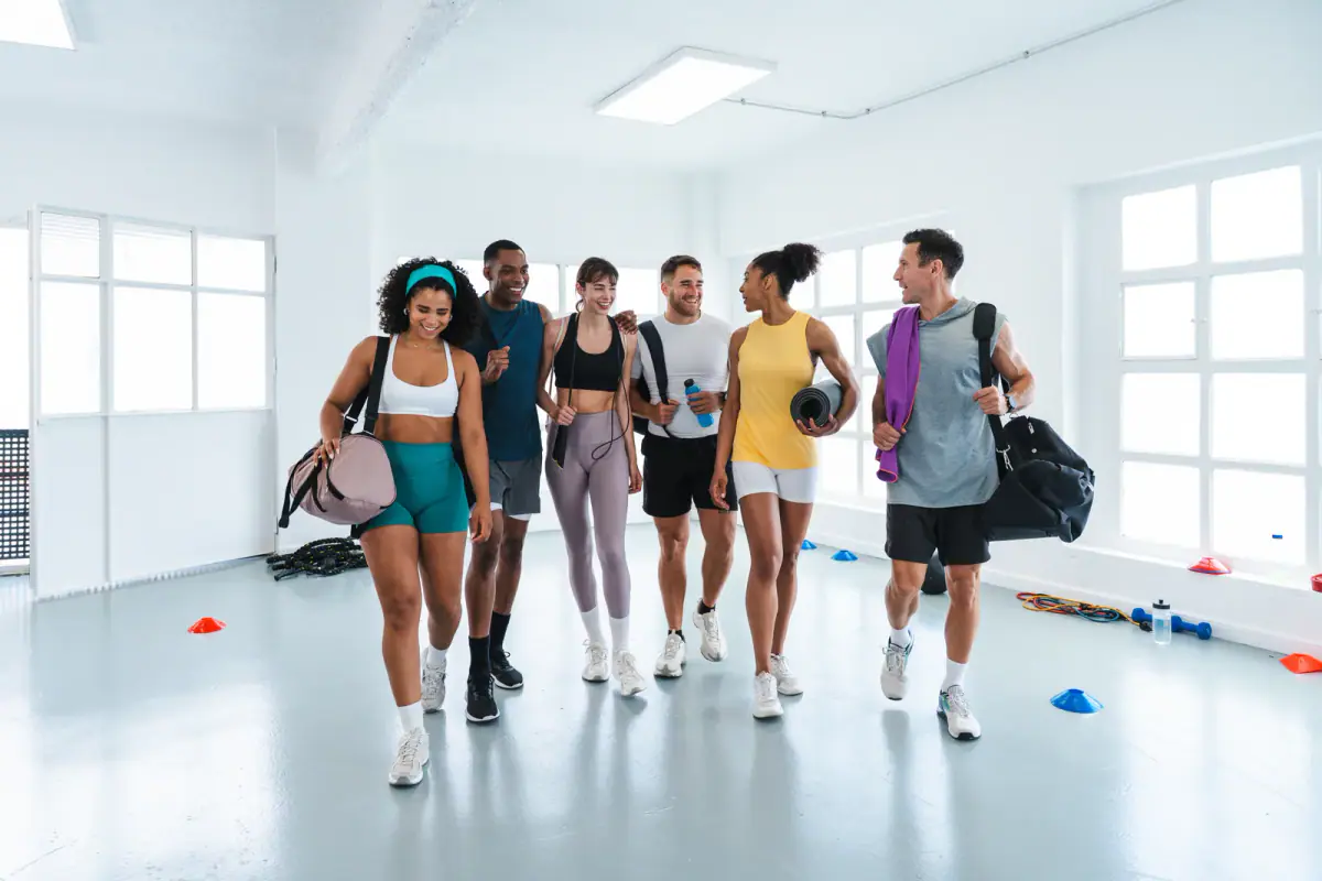 A group of athletes leaving the gym after a functional training workout, relevant to rebranding after leaving a gym