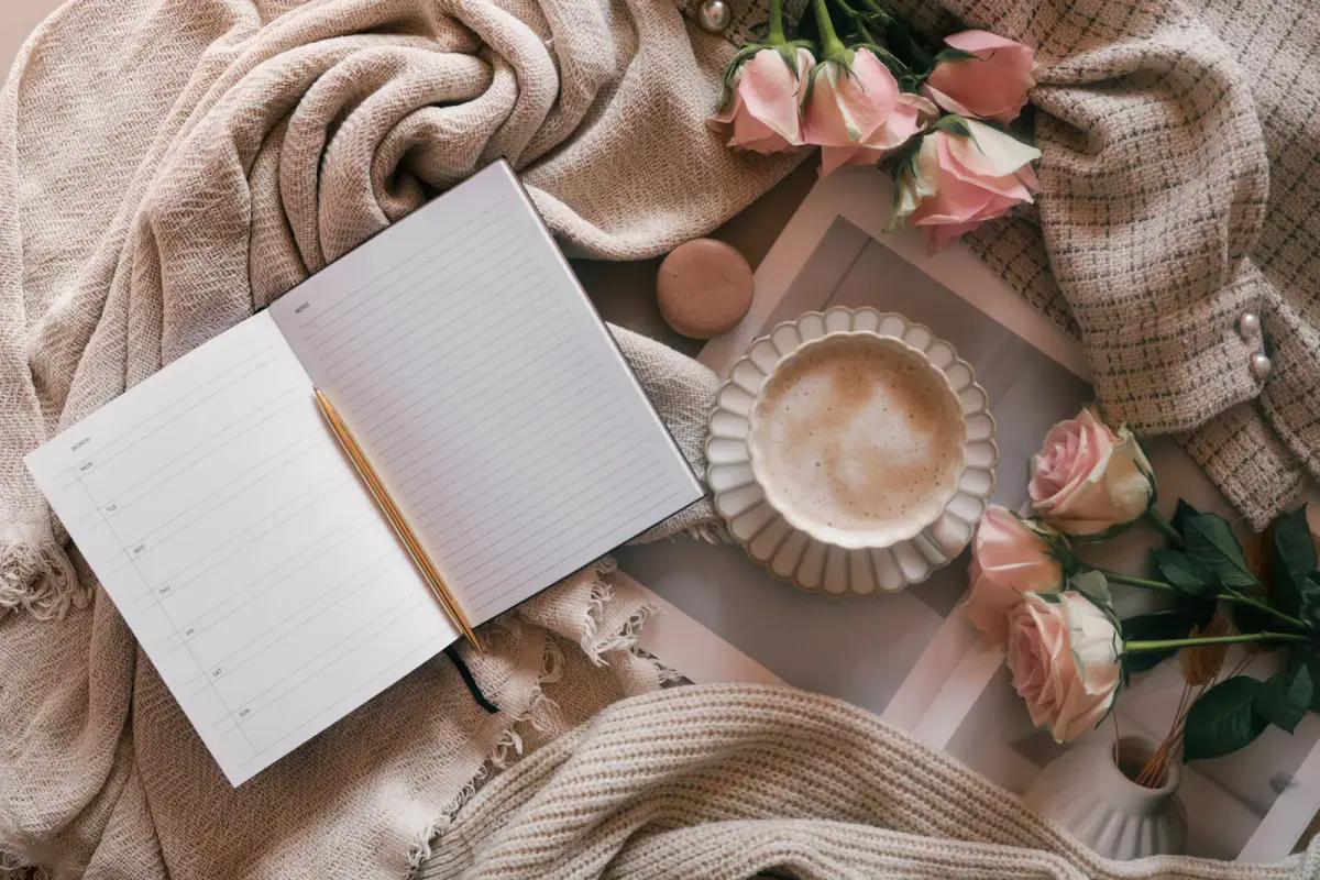 Open weekly planner with a pen, coffee cup and pink roses, a view of a recurring weekly slot vs booking as needed