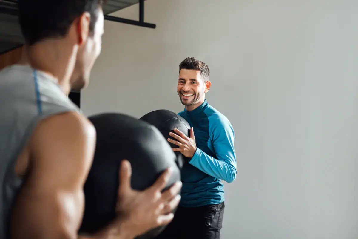 Fitness instructor demonstrating a movement while teaching a small class