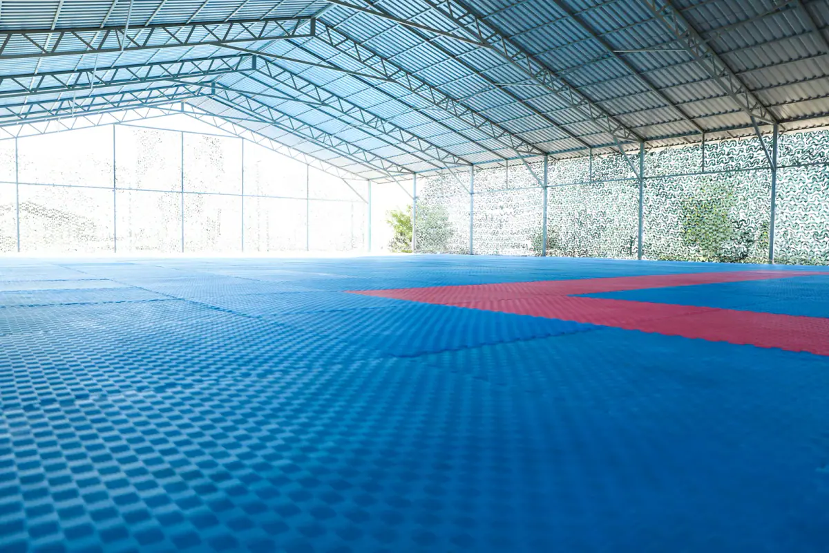 An empty martial arts pavilion with tatami flooring, relevant to renting a studio floor for training