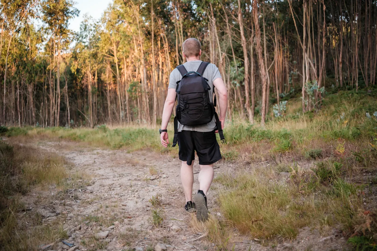 Person walking with a weighted backpack for rucking training
